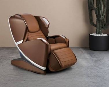 Cognac brown massage chair with white trim beside a potted cactus