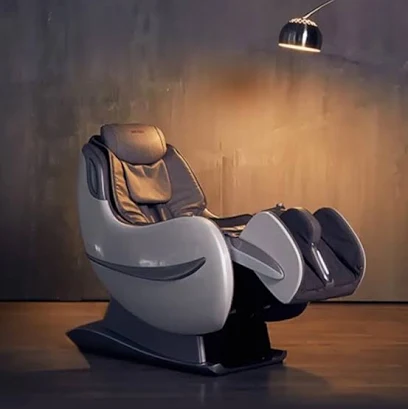 Ivory shell massage chair with dark upholstery on a pedestal base under a floor lamp